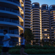 Joggers pass the largely vacant Cape Royale condominium in Sentosa Cove on Singapore's Sentosa island August 19, 2014. There's an eerie silence at night in Sentosa Cove, the man-made island resort billed as Singapore's answer to Monte Carlo and the only place in the country where foreigners can buy landed property. Dozens of houses - complete with their own private yacht berths and multiple swimming pools - sit empty while few lights are on in the apartment blocks overlooking the marina, a few kilometres away from Sentosa's giant casino. Picture taken August 19, 2014. To match SINGAPORE-PROPERTY/ REUTERS/Edgar Su (SINGAPORE - Tags: BUSINESS REAL ESTATE) - GM1EA8T0D6U01